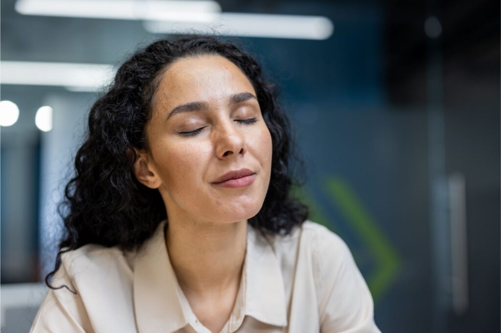 Relaxed Hispanic businesswoman with her eyes closed