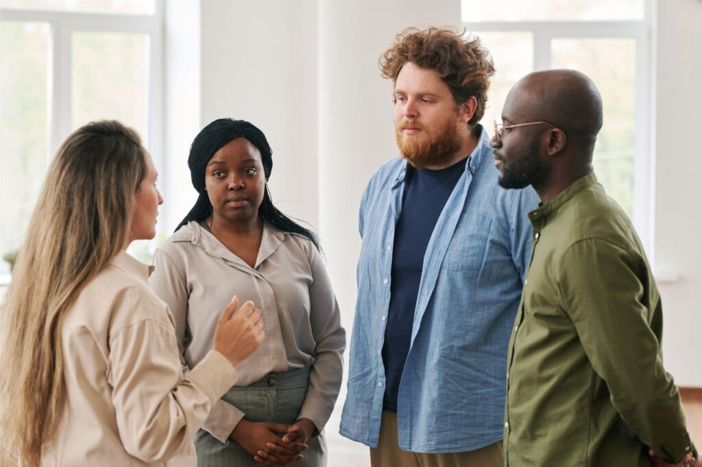 Leader managing conflict and team dynamics speaking to diverse team