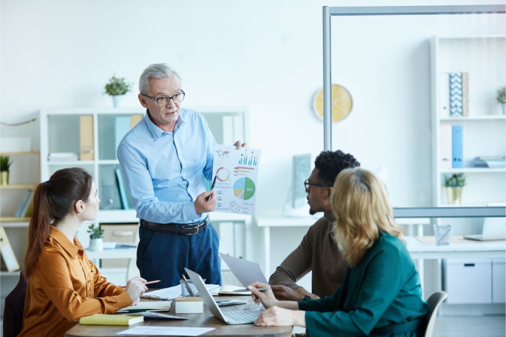 Mature leader presenting report for employees