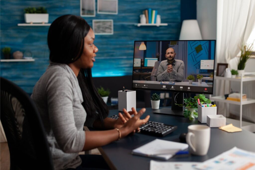 Employee receiving feedback from manager on online video call