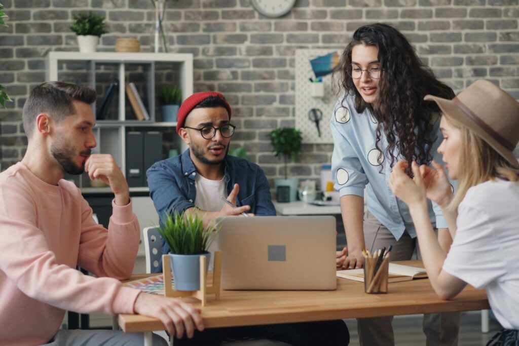 Coworkers collaborating in a meeting, highlighting relational resilience and clear communication at work.